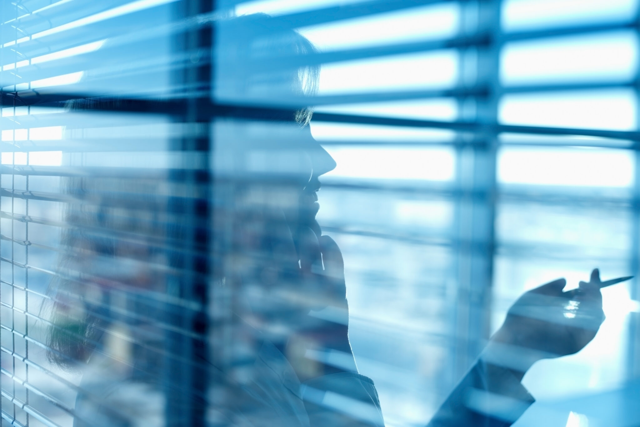 woman in office talking on phone near blinds 2026 03 09 03 22 52 utc scaled